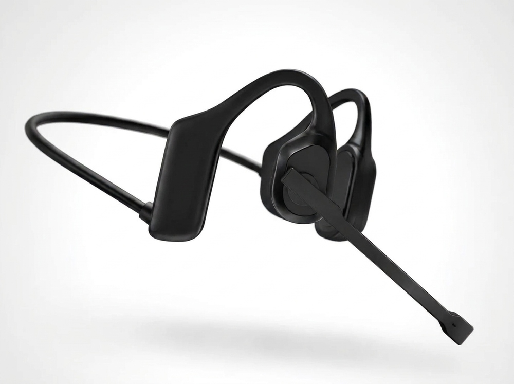 Black bone-style over-ear headphones with an attached boom microphone, shown floating against a clean light gray background.